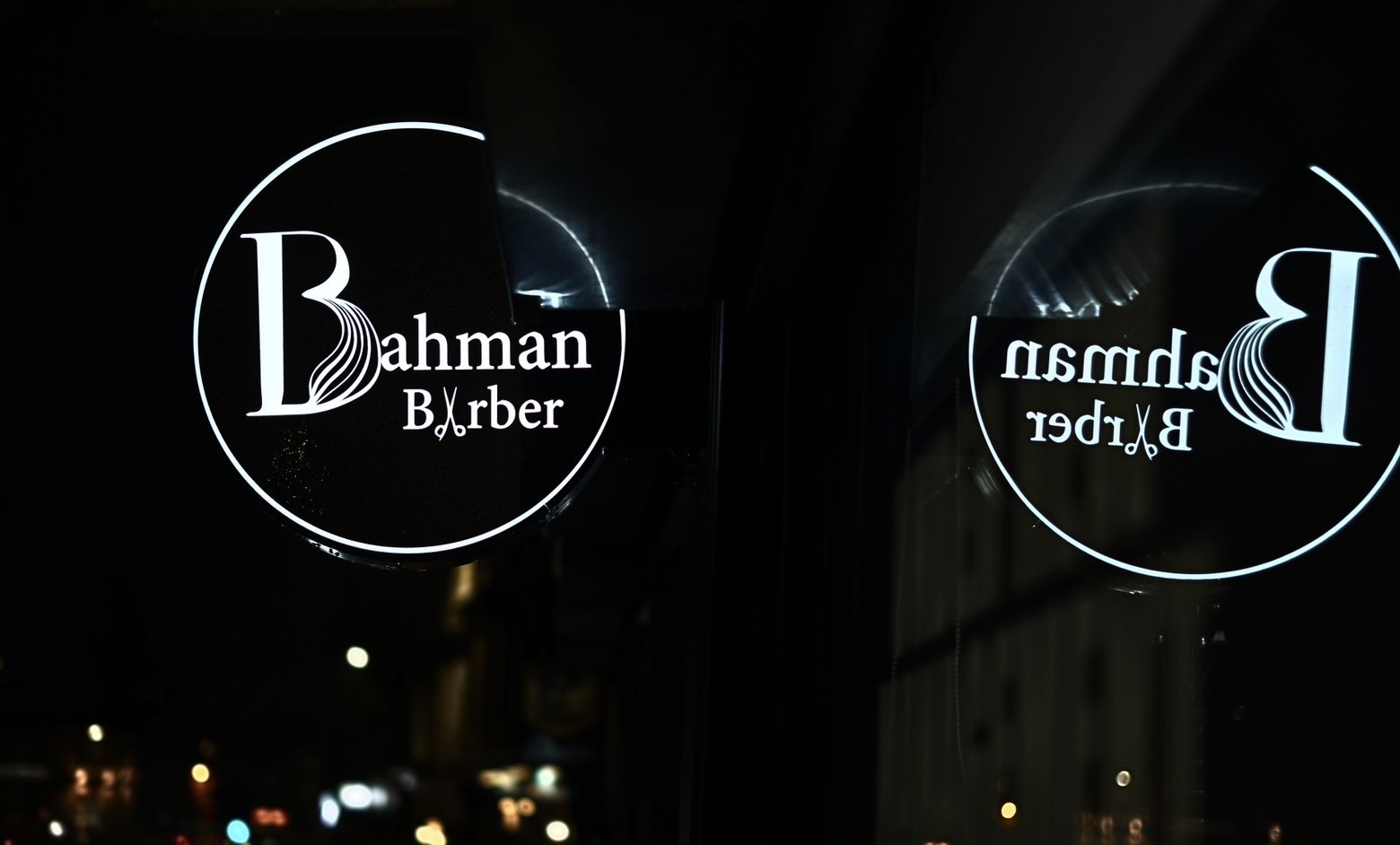 Bahman Barber window sign at night